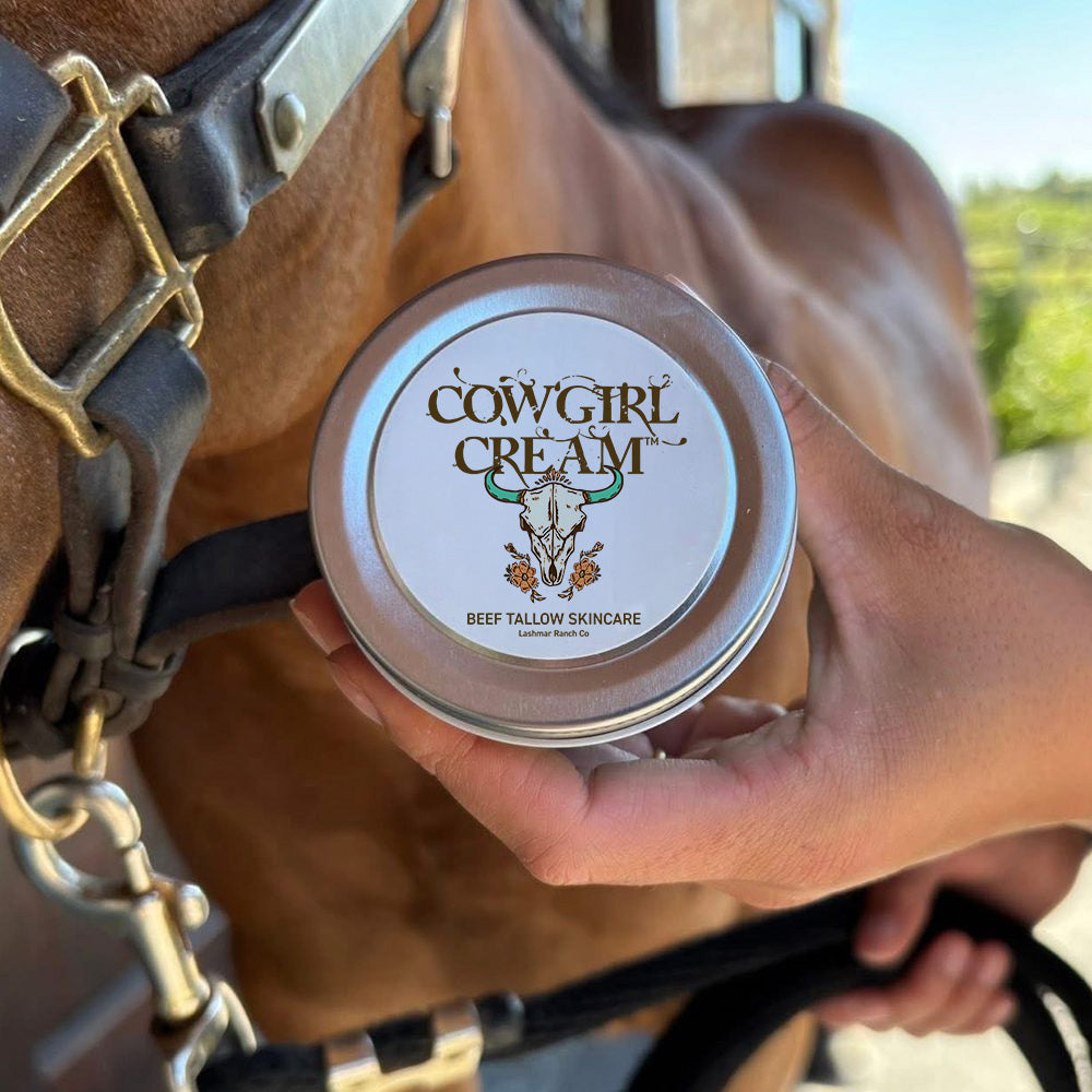Person holding a container of 'Cowgirl Cream' with a horse in the background